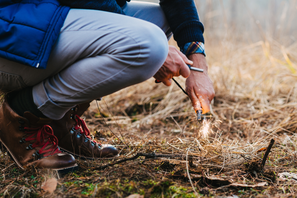 A man makes a fire with a flint