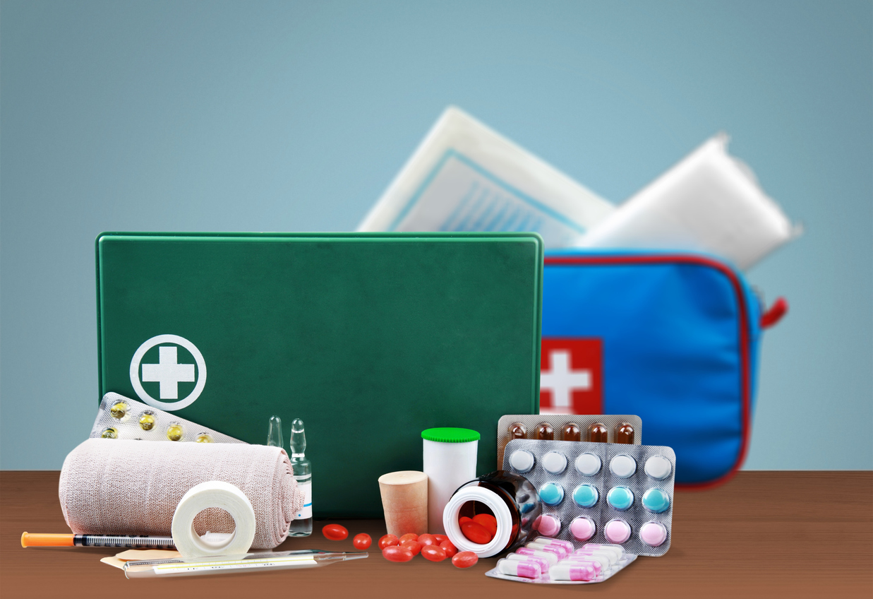 First aid kit  with medical supplies on light background